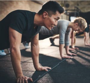 group of people doing pushups